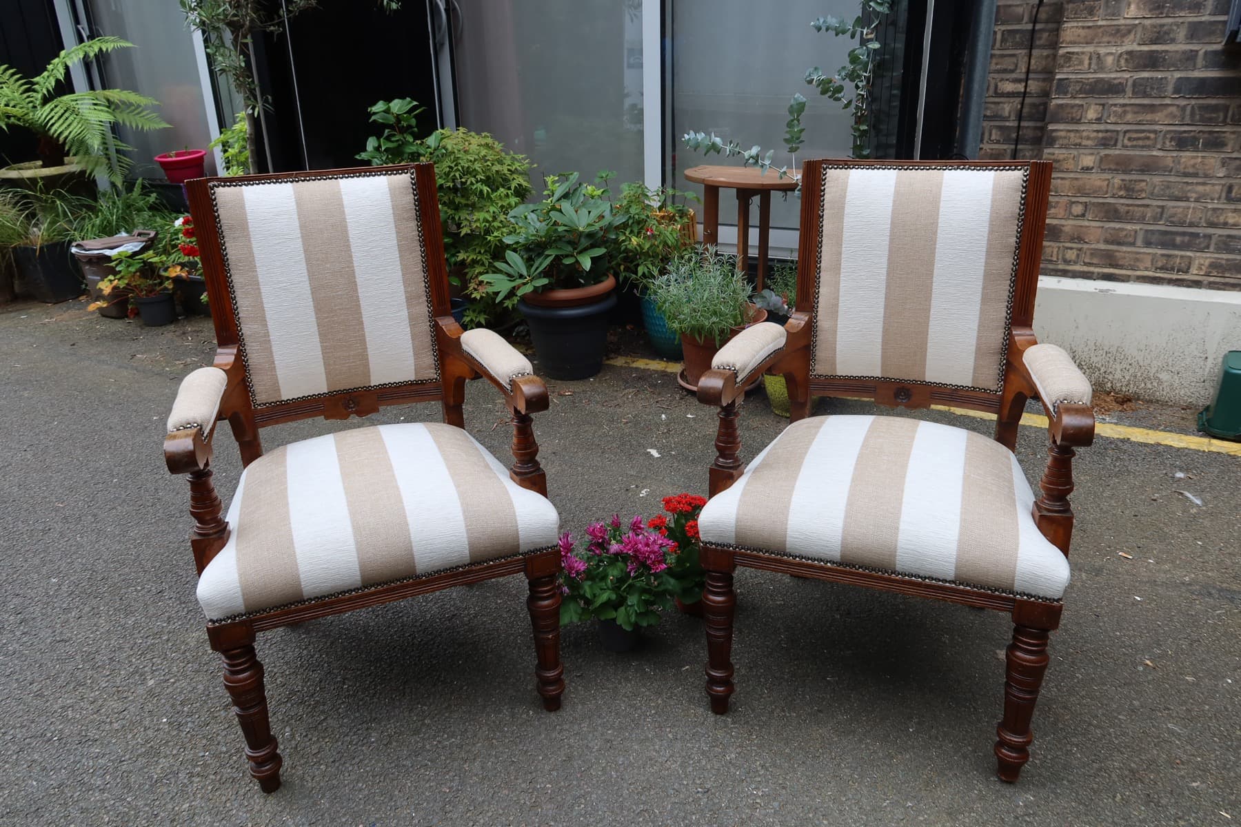 Separate finished example of armchairs in striped fabric with nailhead trim