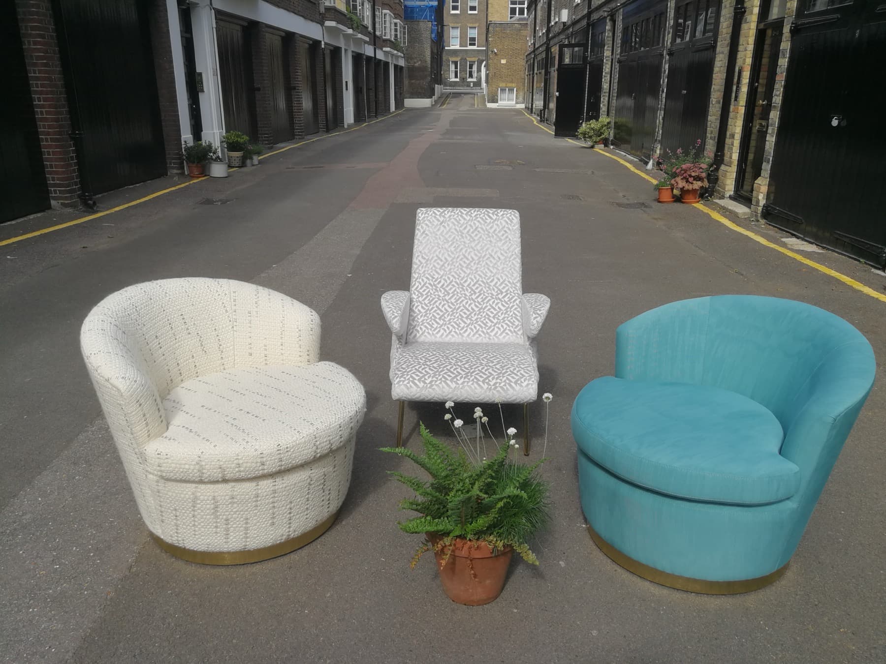 Three armchairs reupholstered in different upholstery fabrics
