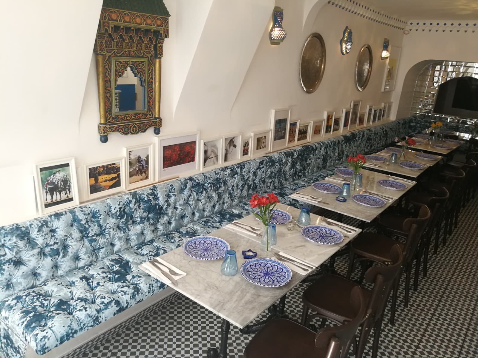 Restaurant banquette seating with deep-buttoned upholstery in a Moroccan-style dining room